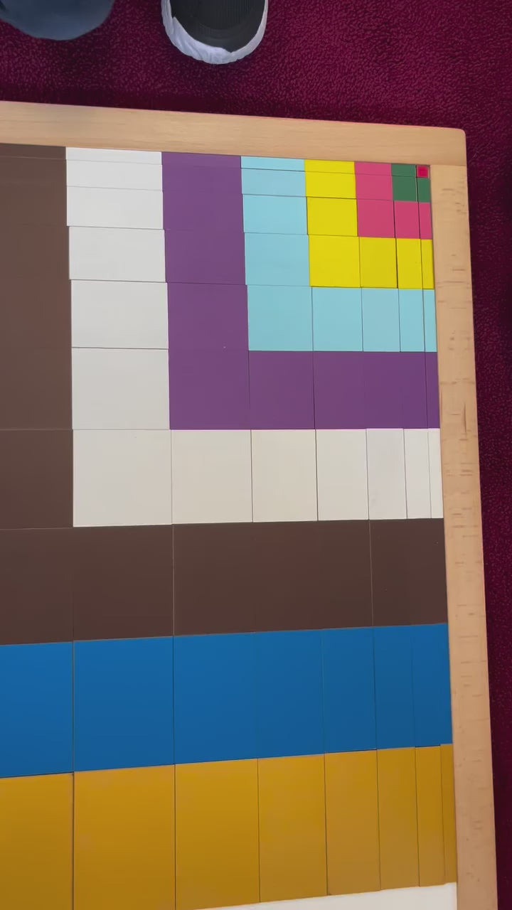 Close-up view of colorful geometric block pattern arranged inside a wooden learning board.
