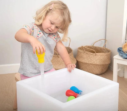 Child using rainbow sensory water play set for hands-on STEM and sensory learning