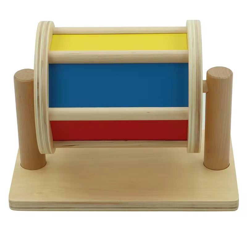 Back view of wooden rainbow spinning drum showing blue yellow and red panels