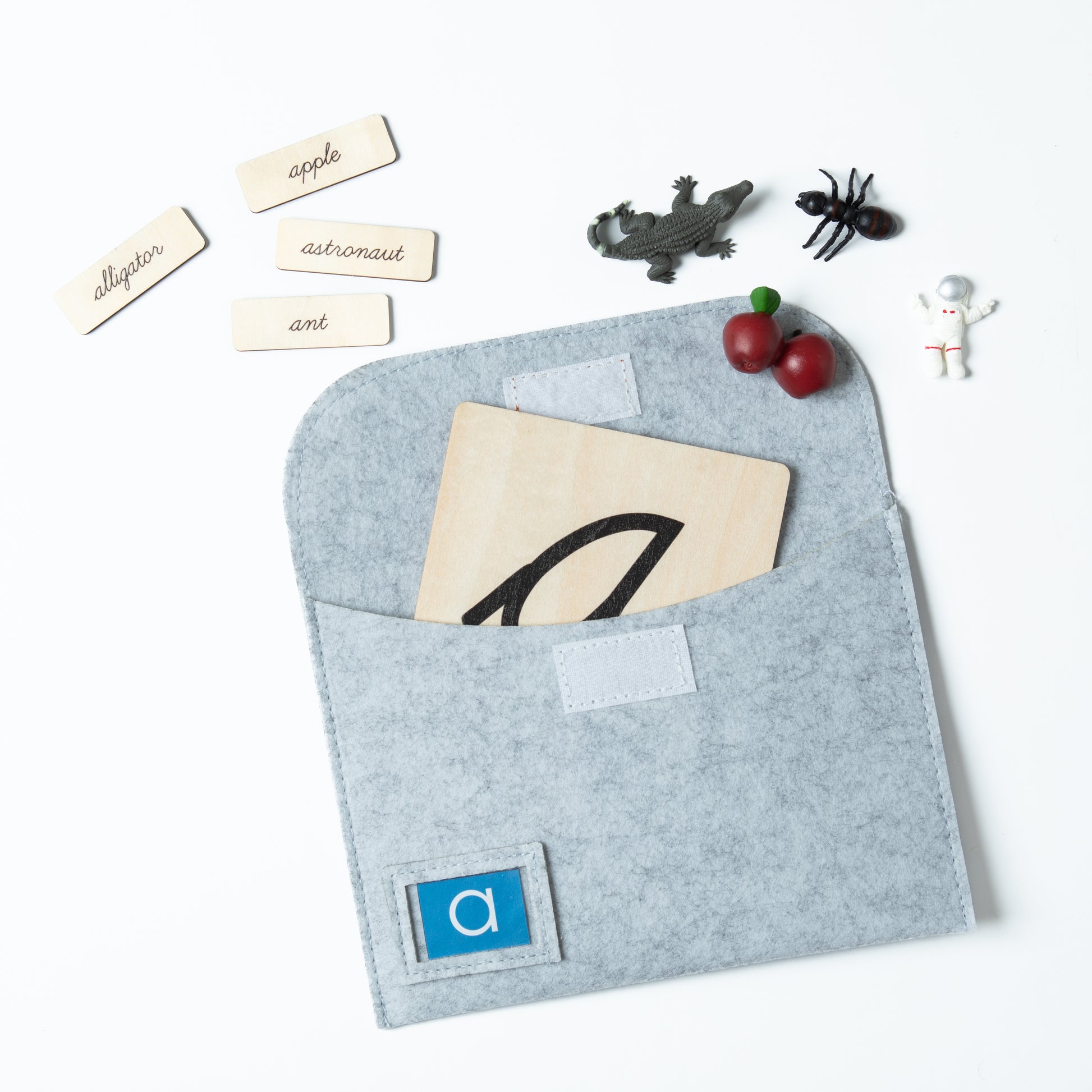 Montessori sound pouch for letter O with cursive card and language objects