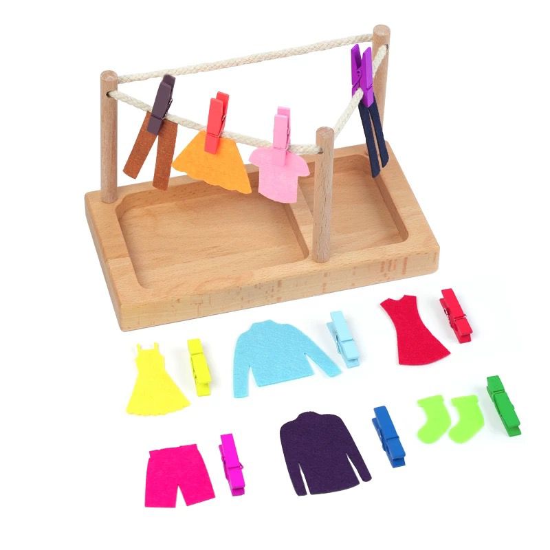 Toddler using Montessori clothesline pegging activity