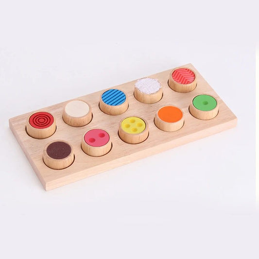 Wooden Montessori tactile touch and match board with 10 textured cylinders arranged on a wooden base.