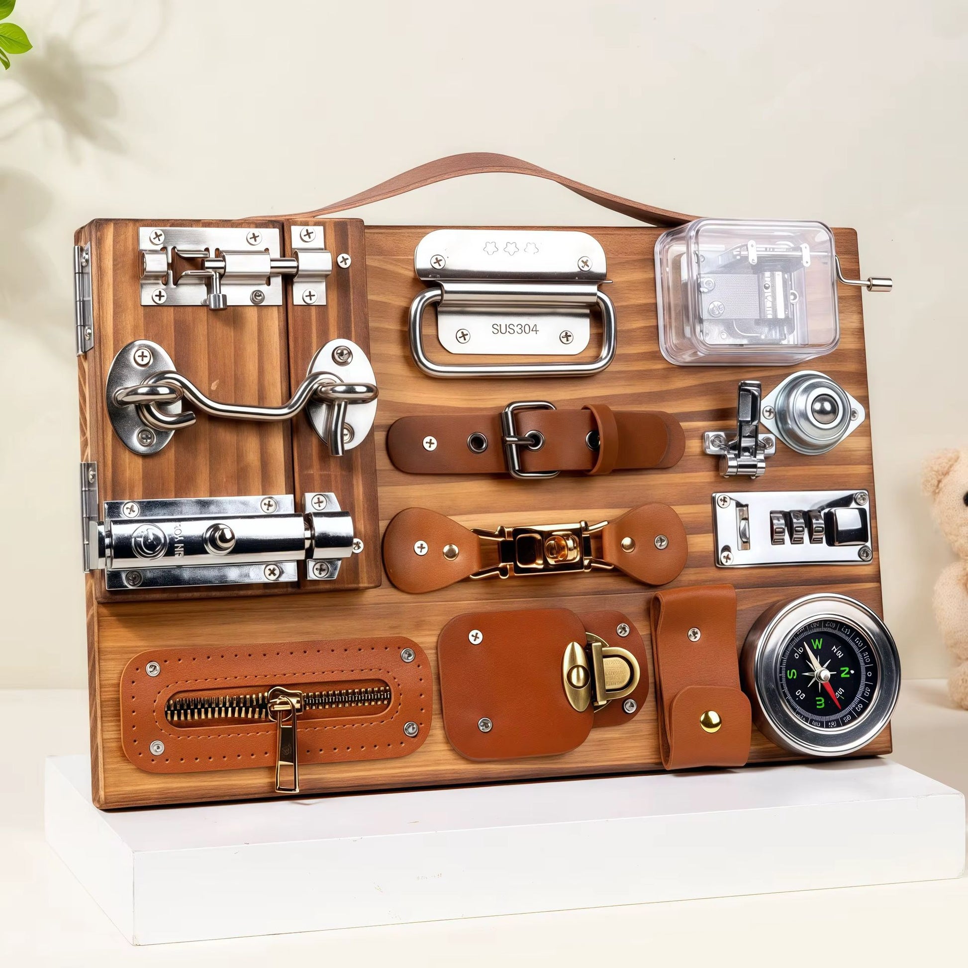 Wooden busy board with musical box, compass, latches, and practical life activities for fine motor skill development