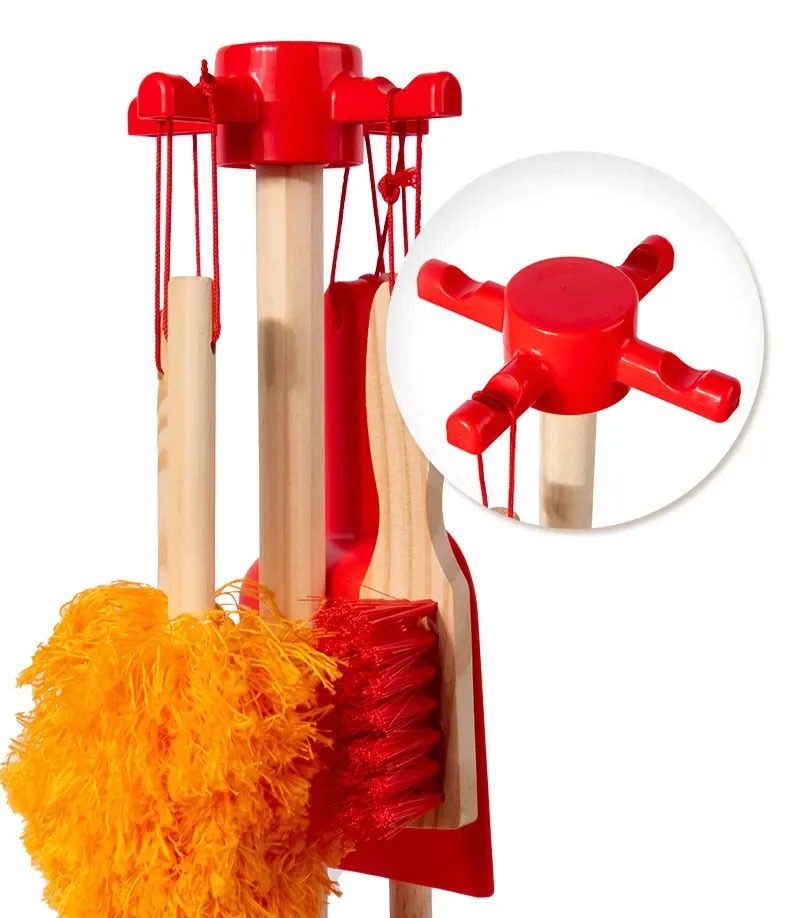 Close-up of wooden mop, broom, duster, and cleaning accessories from a Montessori cleaning set