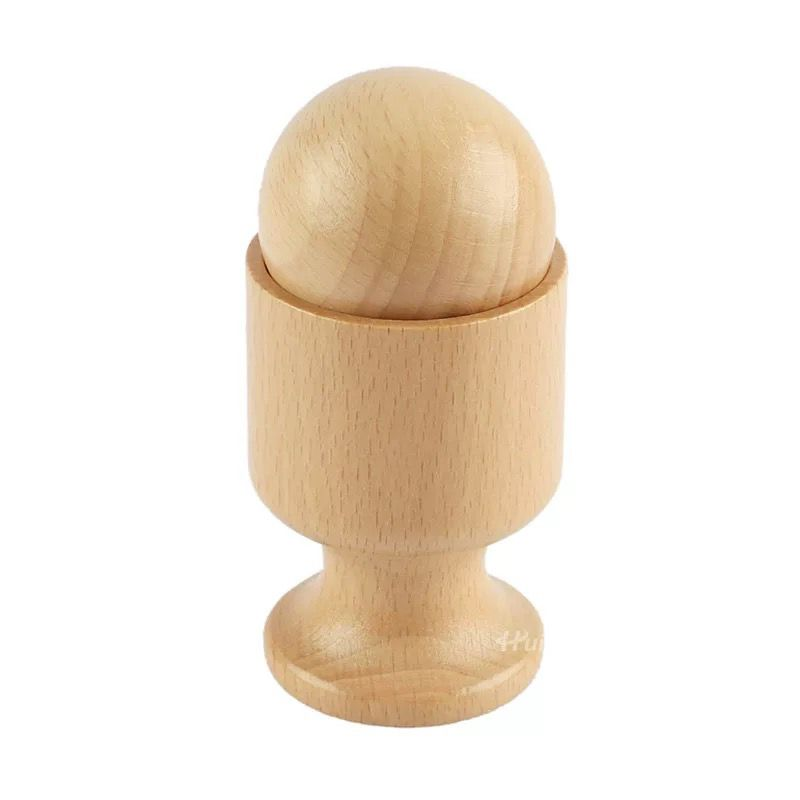 Natural wooden Montessori toy featuring a smooth wooden egg placed inside a matching wooden cup stand on a light background.