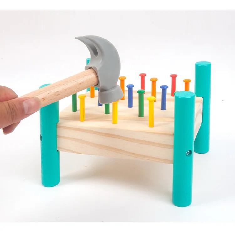 Peg pounding action using wooden hammering toy for sensory and motor skill development