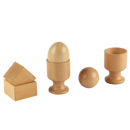 Wooden educational toy set featuring cube blocks, a wooden egg in a cup stand, a wooden ball, and an empty cup holder on a light background.